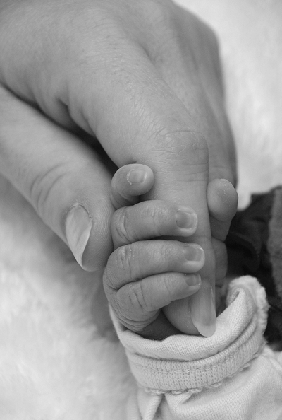 mom holding a baby's hand